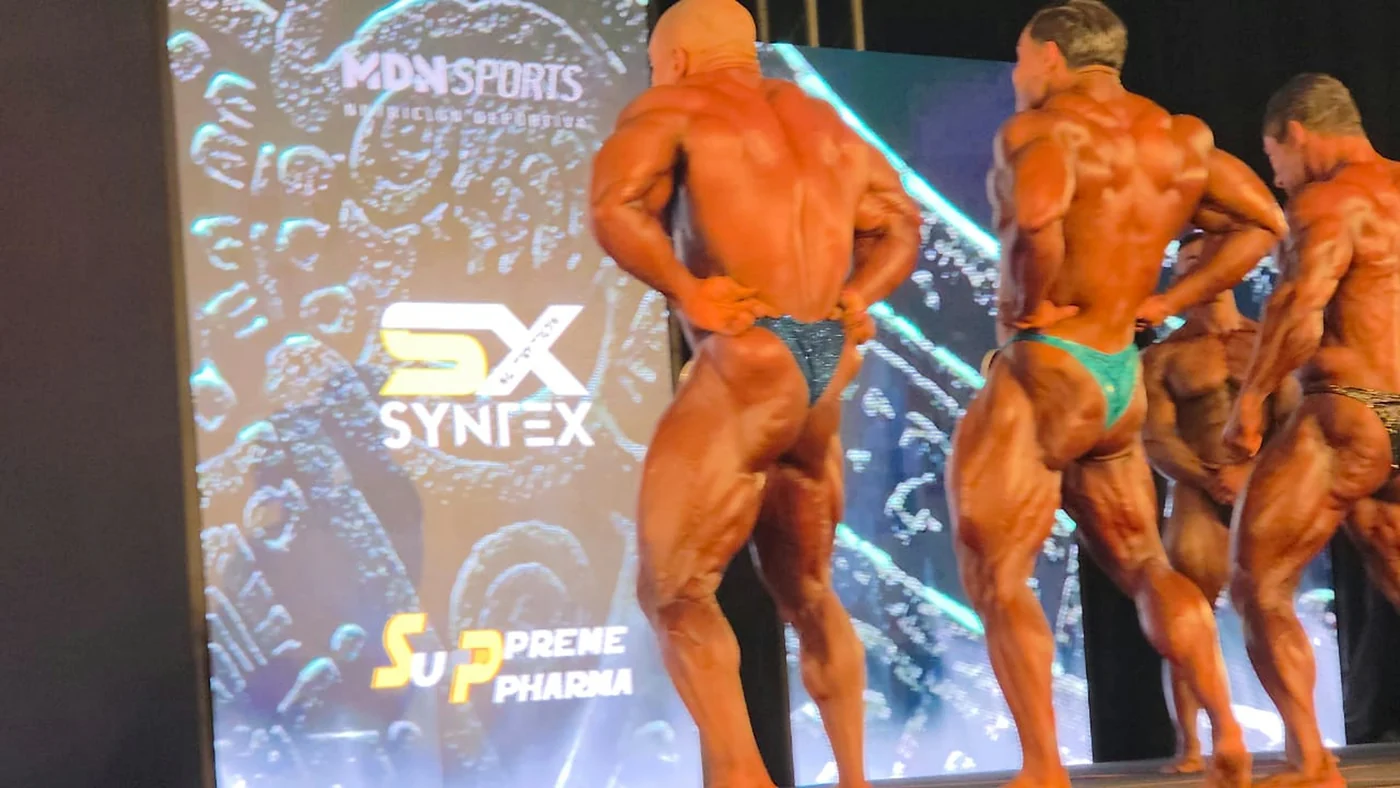 Line of athletes on stage in front of the Syntex backdrop
